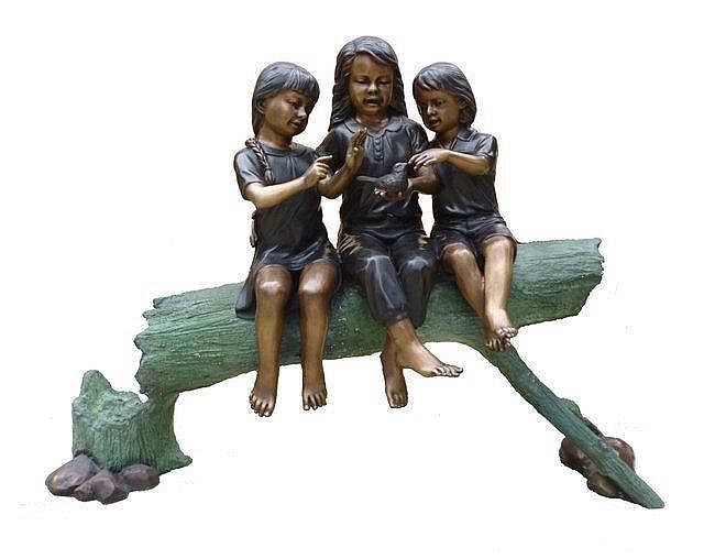 Three Girls Sitting on the Log with a Bird Sculpture